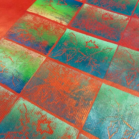 Handprinted Christmas wrapping paper with red and green festive pattern