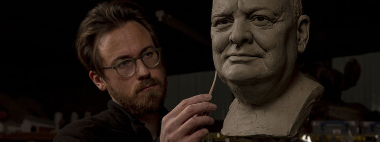 Jethro Crabb sculpting a clay head of Churchill.