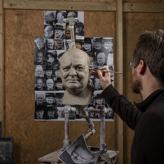 Jethro Crabb in his studio sculpting the head of Winston Churchill