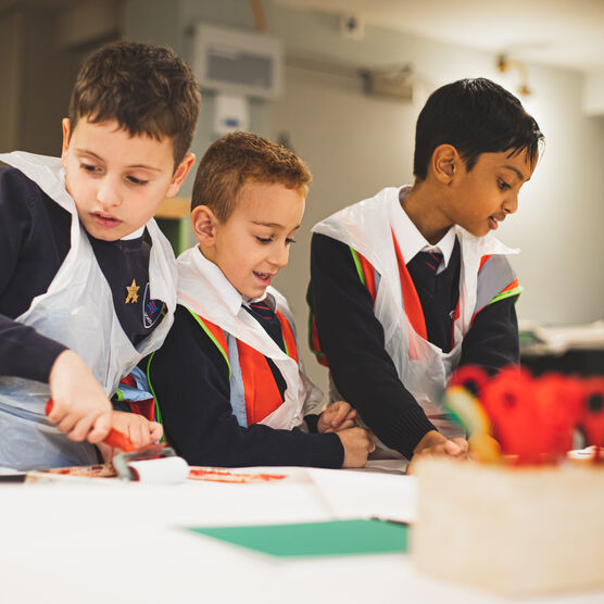 Three boys taking part in a crafts workshop at Watts Gallery