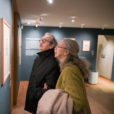 Man and woman looking at artwork on the wall