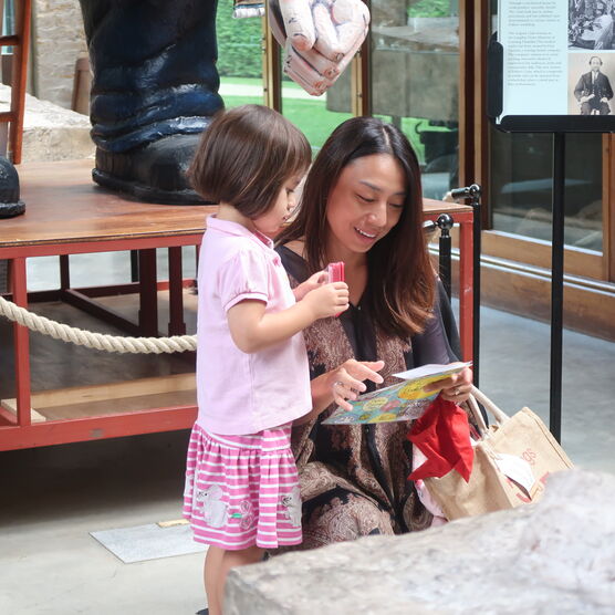 A women and her daughter look at a gallery map in the Sculpture Gallery