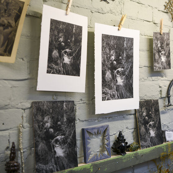 A selection of prints hang from a string in the artist-in-residence studio