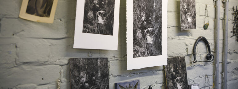 A selection of prints hang from a string in the artist-in-residence studio
