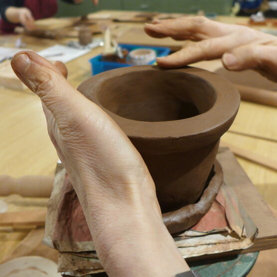 Hands moulding clay