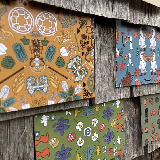 A collection of postcards containing a limner collection pattern inspired by the chapel are stuck into slats of wood, mimicking roof tiles