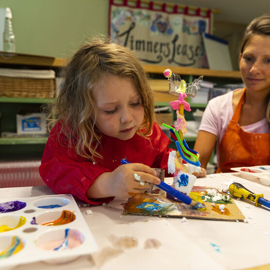 Child makes a colourful sculpture in Watts Tots craft workshop