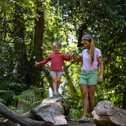 Mother and child playing in a woodland playground