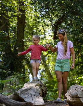 Mother and child playing in a woodland playground