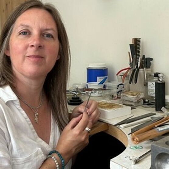 Photo of Kerry Tristram, an adult woman with brown hair, in her studio