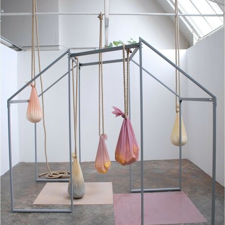 Photo of an abstract sculpture made from metal frames and pieces of cloth that are filled and tied to the sculpture