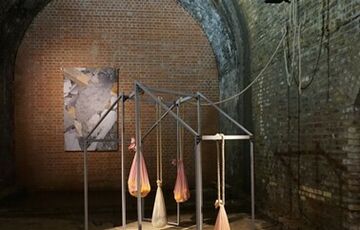 Photo of an abstract sculpture made from metal frames and pieces of cloth that are filled and tied to the sculpture