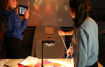 Two students doing light projections