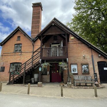 The visitor centre is a red brick building with an arched roof. There is a staircase along the side to allow access to a second story entrance