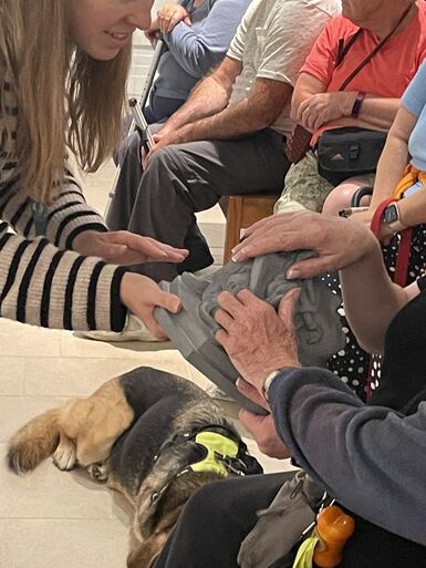 Community programme curator Kate shows a 3D model of the head of Medusa to a visitor, who is running their hands over it