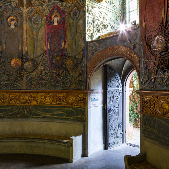 The door to the Chapel from the inside. There are stone benches around the base circle and the door is open