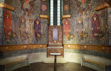 The inside of the chapel with intricate and colourful panels