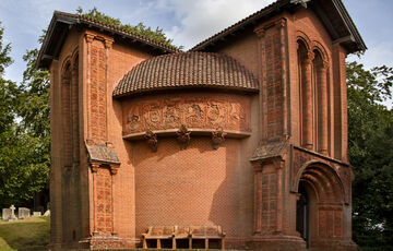 A terracotta celtic-style chapel with decorated tiles