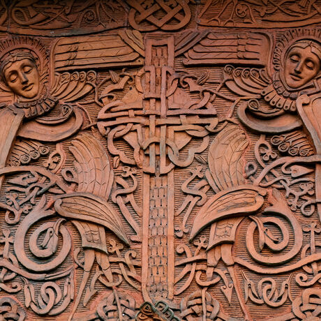 Terracotta panels on outside of chapel, featuring celtic symbols and two angels