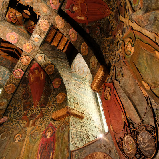 Highly decorate Watts Chapel ceiling interior with colourful symbolist panels