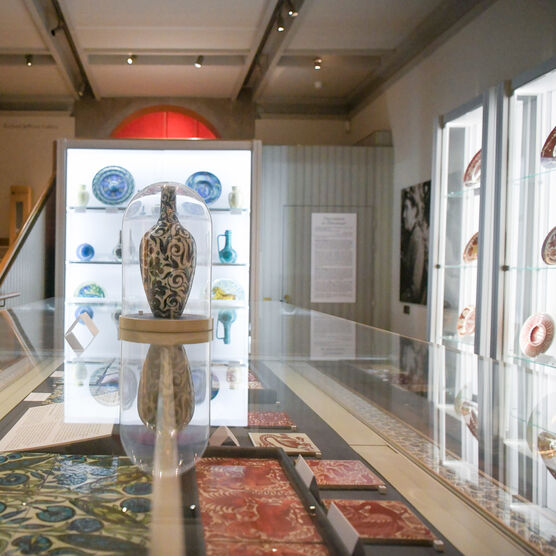 Glass case with tiles and a vase