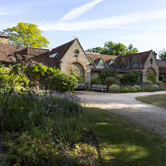The outside of Watts Gallery with flower bed in foreground