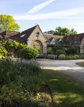 The outside of Watts Gallery with flower bed in foreground