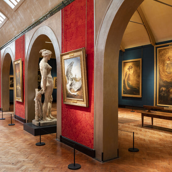 Inside of gallery with paintings and sculptures