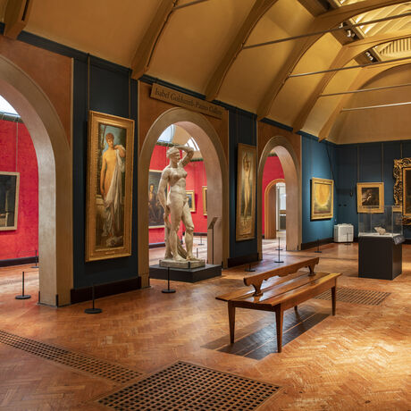 Historic gallery features oil paintings in gold frames and sculptures