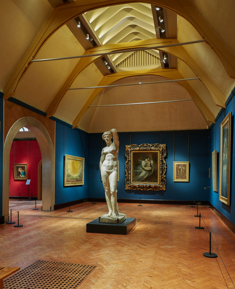 The Historic Galleries with paintings on the wall and a nude sculpture in the centre