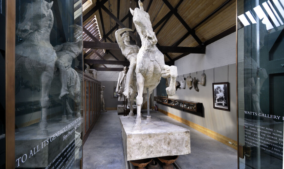 Large plaster sculpture of a man riding a horse, located in the Sculpture Gallery.