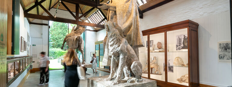 Inside of sculpture gallery featuring large statues and smaller models