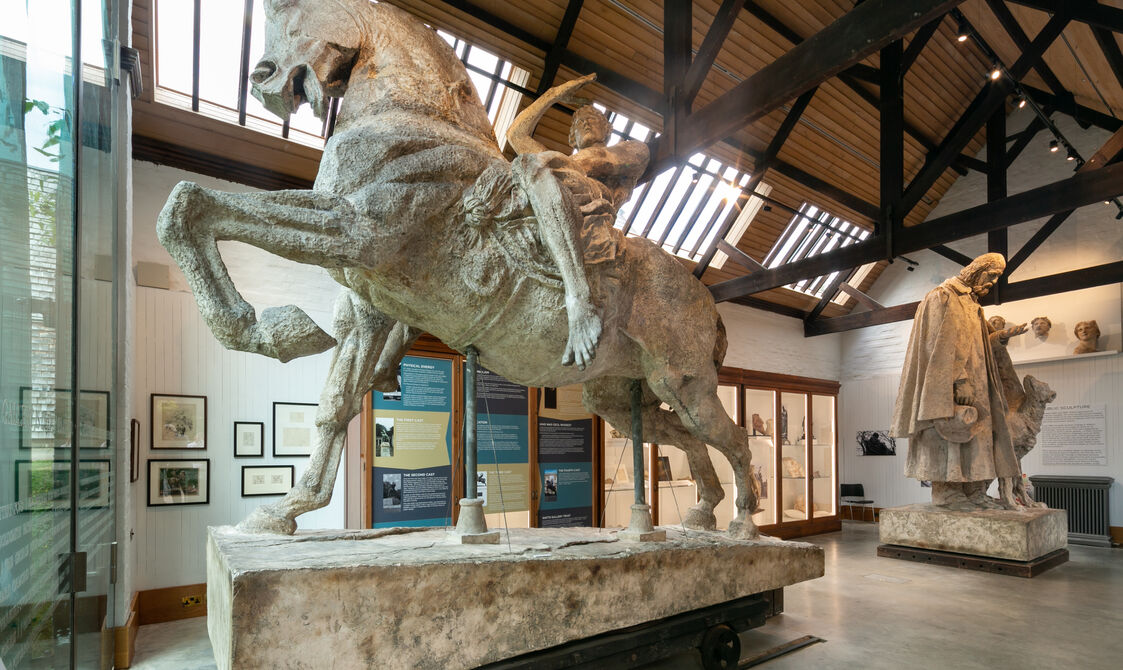 Large sculpture of a man riding a horse in gallery