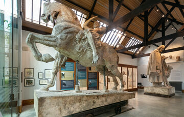 Large sculpture of a man riding a horse in gallery