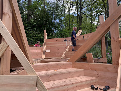 A builder works on wooden amphitheatre