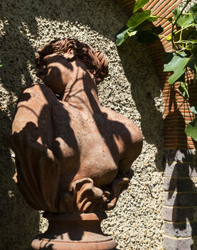 Terracotta sculpture of women's head turning to one side