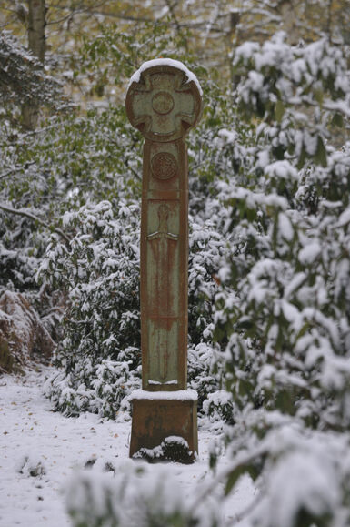 Terracotta free standing cross in snow
