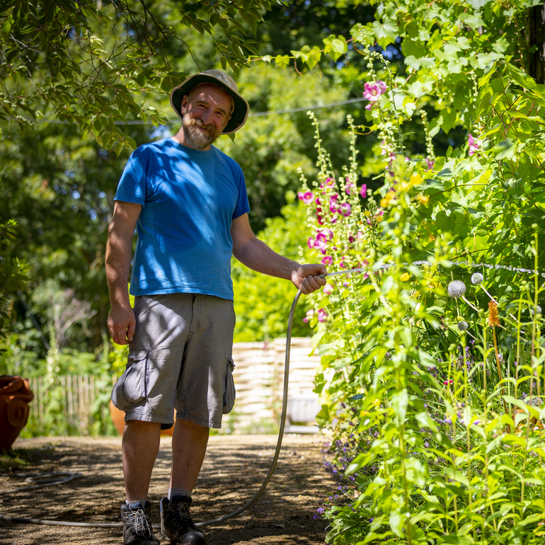 Chris Sharples, Verey Head Gardener waters the gardens at Watts Gallery
