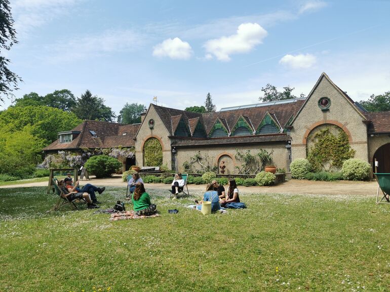 Group of people enjoying a picnic on the lawn outside the Historic Gallery