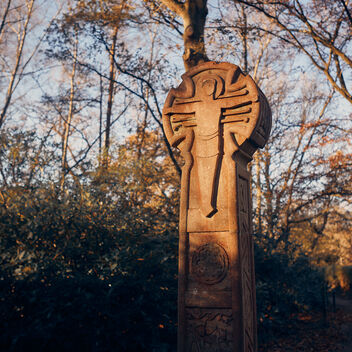 A celtic style cross in the woodlands