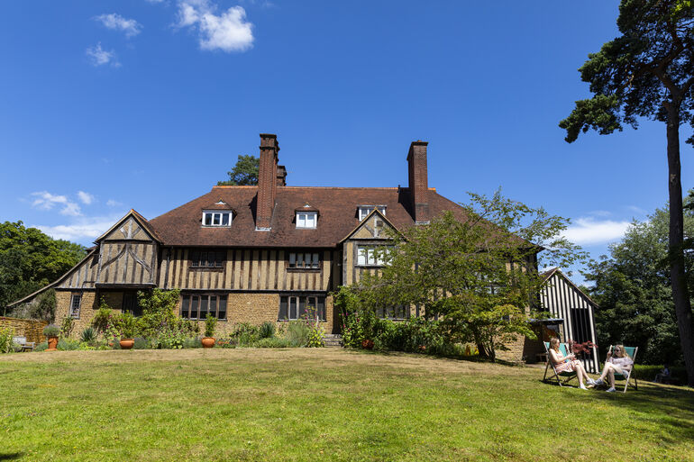Blue sky with historic panelled house