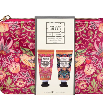 A wash bag with the famous William Morris print on in a pink colour with flowers, berries and birds. Inside the wash bag are two different scented hand creams.