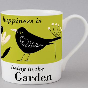 A white mug with a illustration of a blackbird and flowers sitting on a bright green background with the words "Happiness is being in the garden"
