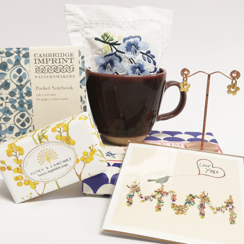 A range of different products from the Watts gift shop including cards, soap, earrings, mug and a notebook