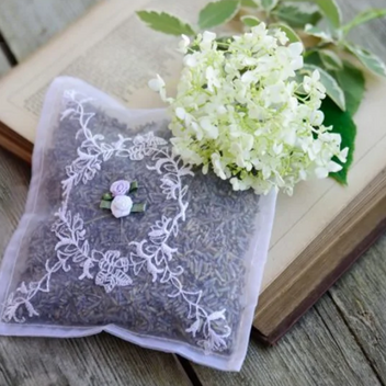 A sachet of lavender placed on a book with a flower