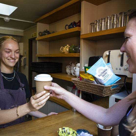 Customer buying takeaway hot drink at Tea Shop at Watts Gallery
