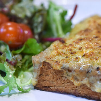 Close up of rarebit with side salad