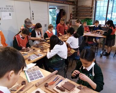 School children in a pottery workshop