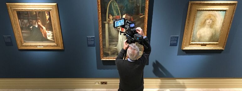 A man films a painting