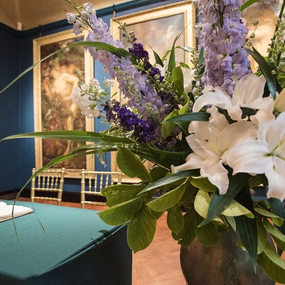Lilies in vase set up for wedding ceremony